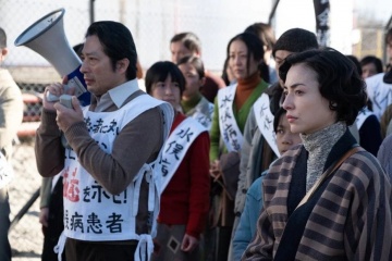 Il caso Minamata - Hiroyuki Sanada 'Mitsuo Yamazaki' con Minami 'Aileen' in una foto di scena - Il caso Minamata